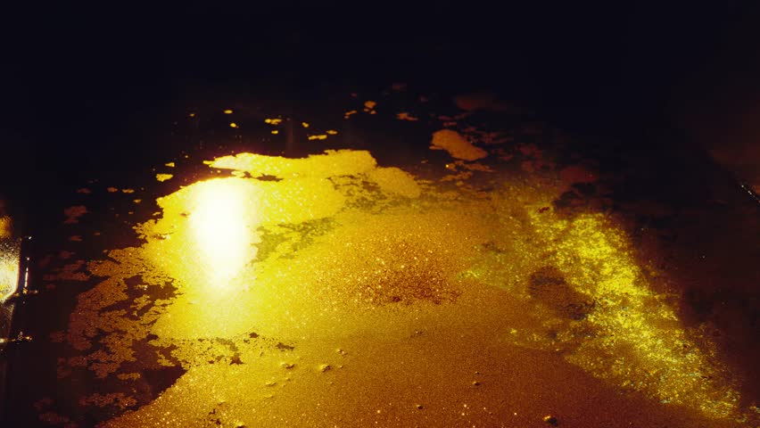 close-up shot of golden powder falling into water golden liquid, magical shiny paint in backlight light flare, dark room night gothic style. Liquid paint bath with salt. concept natural cosmetics 4k Royalty-Free Stock Footage #3456610269