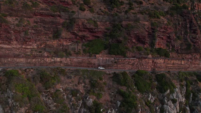 Car Traveling At Chapman's Peak Drive After Sunset In Cape Town, South Africa - Aerial Drone Shot Royalty-Free Stock Footage #3456615299