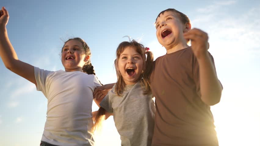 group of kids team hugging a jumping and rejoicing outdoors. happy family teamwork kid lifestyle dream concept. family children sisters brothers have fun hugging in the park in nature Royalty-Free Stock Footage #3456616597
