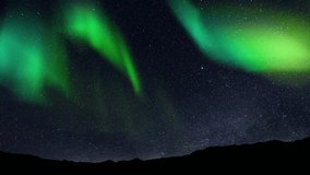 Aurora Borealis interweaving with the Milky Way Galaxy. Northern Lights Time Lapse Solar Wind. Dance of Celestial Lights. Northern Lights twirling with solar wind flaring in green and purple - Powered by Shutterstock - Get 15% off with code: PIKWIZARD15