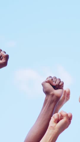 Different fists of people waving in the air