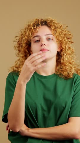 Studio video of a bored woman with curly hair