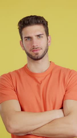 Serious man standing with arms crossed looking at camera