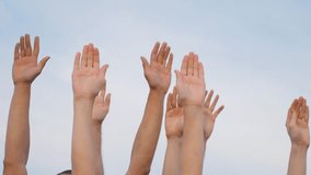 Teamwork. A group of people against the sky raises their hands up. The concept of voluntary voting, expression of consent, support for democracy. people raise their hands together voting with hands - Powered by Shutterstock - Get 15% off with code: PIKWIZARD15