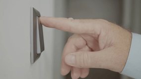Blurred Shooting with a Person Opening the LED Light in the Office from the Switch on the wall. Man Turning OFF the Light in a Room, Saving Electricity, Concept of Energy Economy. - Powered by Shutterstock - Get 15% off with code: PIKWIZARD15