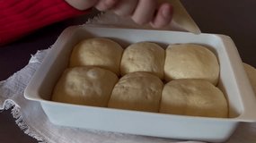 Close up of woman's hands making lines on raw hot cross buns  - Powered by Shutterstock - Get 15% off with code: PIKWIZARD15