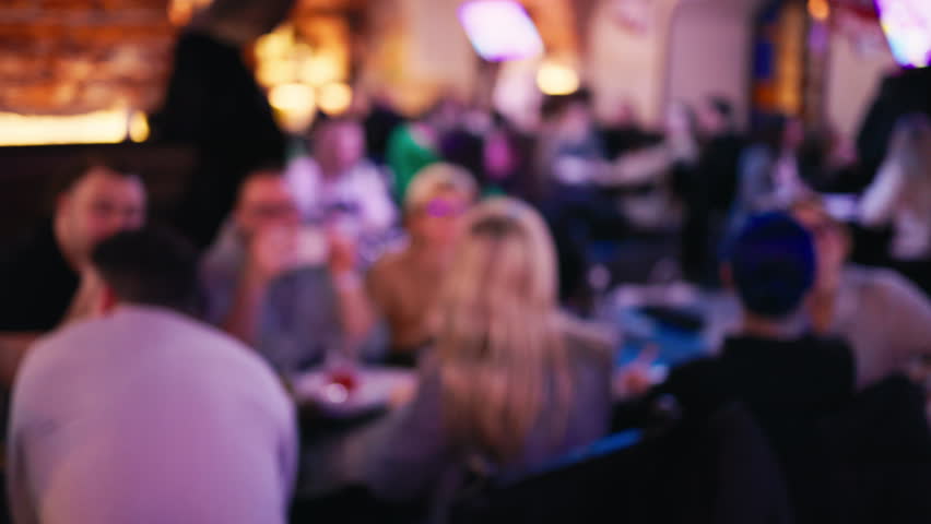 Inclusive gathering: Defocused copy space showcases the lively atmosphere as many individuals, representing various backgrounds, chat and relish drinks