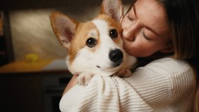 Heartwarming connection: Young woman cherishes and adores her corgi dog at home