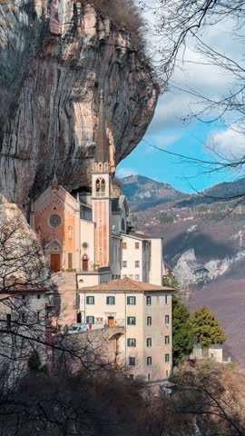 Medieval church Santuario Basilica Madonna della Corona on the cliffs Verona, Italy. Vertical video. 