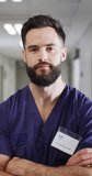 Vertical video of portrait of happy caucasian male doctor. Global medicine, health, lifestyle and hospital concept.