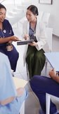 Vertical video of diverse doctors sitting and discussing. Global medicine, health, lifestyle and hospital concept.