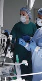 Vertical video of diverse surgeons with face masks during surgery. Global medicine, health, lifestyle and hospital concept.