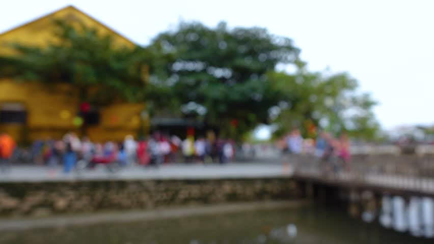 Blurred crowd of different people are walking in Hoi An city 