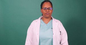 Beautiful young Black doctor flexes arm muscles, strong woman empowerment