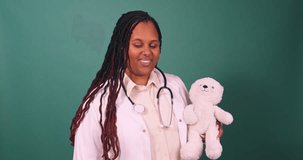 Video of young Black female doctor demonstrates an injection, using teddy bear