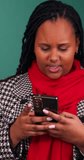 Vertical video of Black woman looking at phone, then pointing at background
