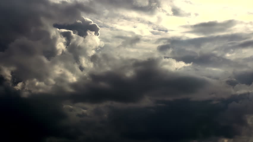 Coming Storm. Timelaps. Clouds cover the sun over the sea. Near the horizon lightning flashes