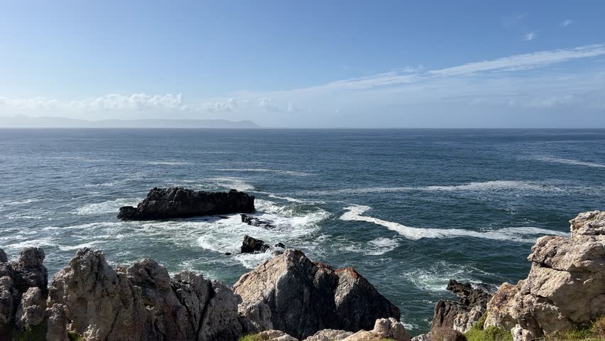 Rugged rocky Whale coast of Hermanus with blue ocean views of Walker Bay Royalty-Free Stock Footage #3457113209