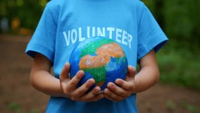 Hands of child volunteer holding earth globe in summer forest, save planet. - Powered by Shutterstock - Get 15% off with code: PIKWIZARD15