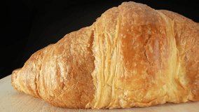 Croissants: Crescent-shaped, but other shapes like straight or curved rolls are common. Enjoyed for breakfast or snack, often with coffee or tea. Junk food concept. Food background. 4K UHD.
