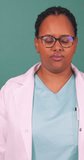 Angry and frustrated young Black female doctor clenches fists getting upset