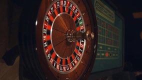 Red color casino roulette, poker game. roulette wheel. Casino theme, betting, online casino, bets, winnings. wooden casino roulette wheel with ball. Luxury roulette. close-up video - Powered by Shutterstock - Get 15% off with code: PIKWIZARD15