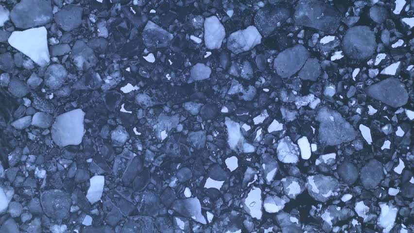 Chunks of broken polar ice floating at surface of Arctic ocean, top-down aerial Royalty-Free Stock Footage #3457194387
