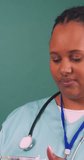 Black female doctor draws up injection, vaccine vial, needle, IVF treatment