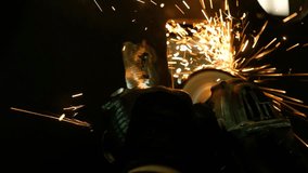 A worker grinding metal with sparks flying in natural light - Powered by Shutterstock - Get 15% off with code: PIKWIZARD15