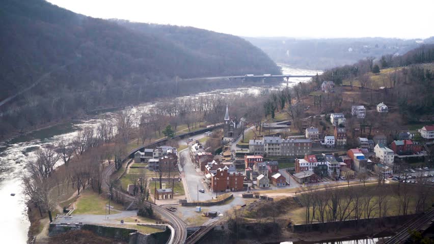 Camera pitches down from view of Harpers Ferry National Park to the railroad tracks and Potomac and Shenandoah Rivers, from Maryland Heights in Maryland.