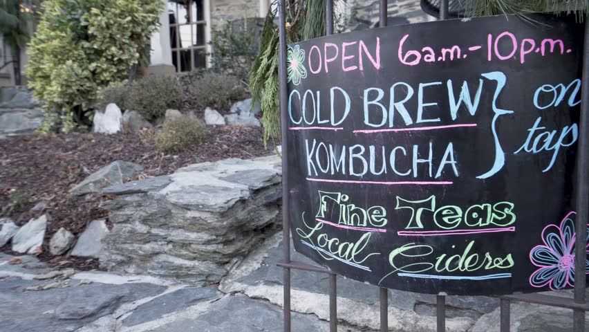 Steadicam gimbal motion of sign for cold brew kombucha on tap and fine teas and local ciders.