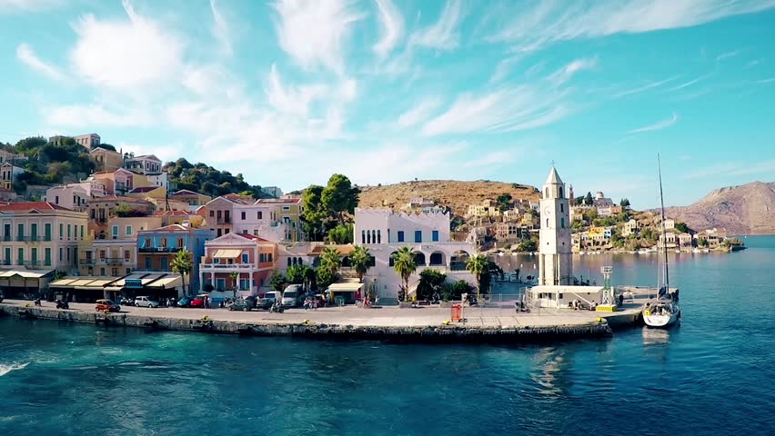 Symi island .beautiful Harbor and a beautiful pier on the background of mountains and blue sky