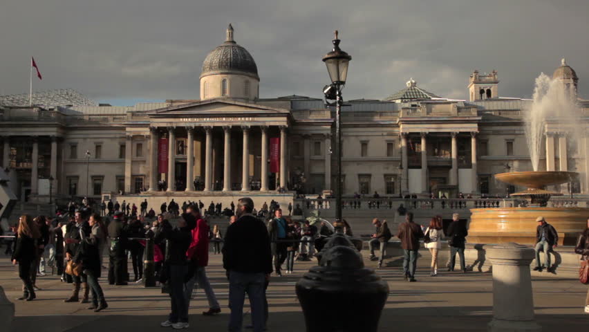 A stationary shot of the National Gallery on Trafalgar Square in London. People