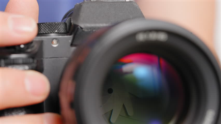 Digital camera in low-light adjusting the electronic autofocus and aperture to take a picture - isolated close up