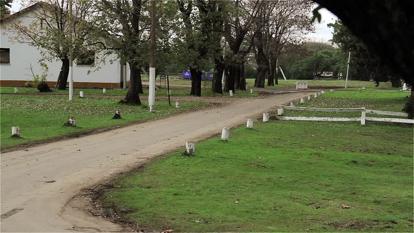 An Armoured Personnel Carrier on Dirt Road at Military Base.
