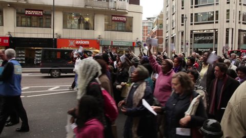 LONDON - OCTOBER 8, 2011: Parade of unidentified people walk in the street 
