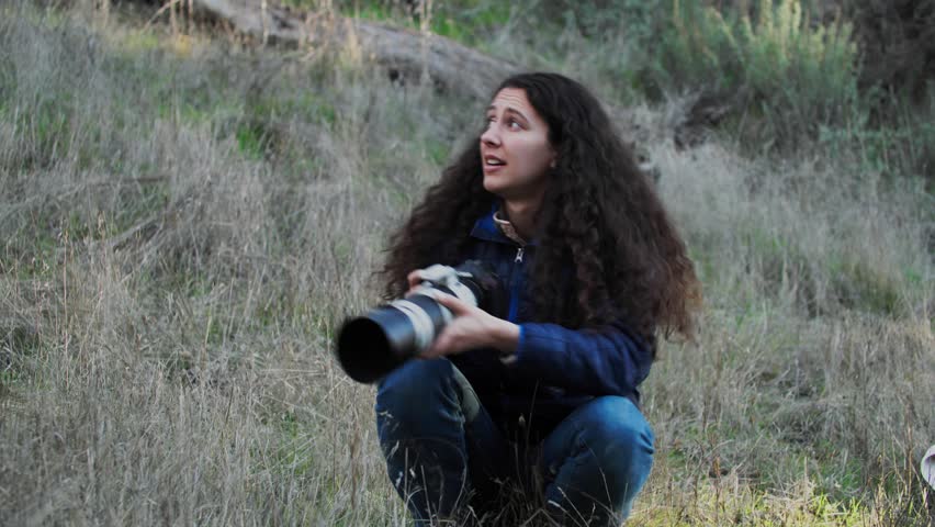 Woman Wildlife Photographer With Telephoto Zoom Lens Taking Pictures of Bird