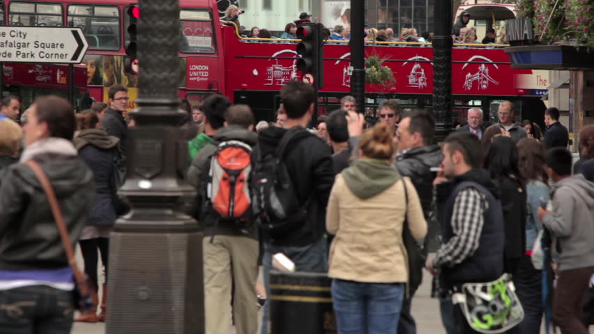 LONDON - OCTOBER 7, 2011: Unidentified people and passing buses on Piccadilly