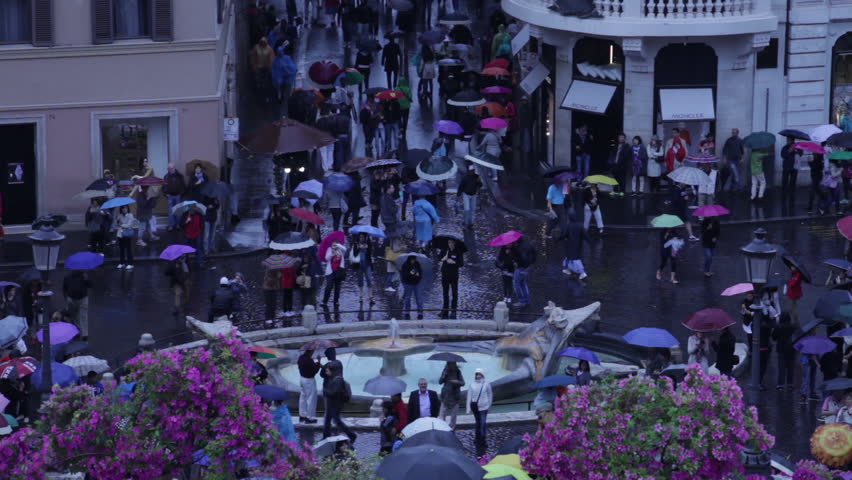Time lapse of tourists touting umbrellas in Piazza di Spagna
