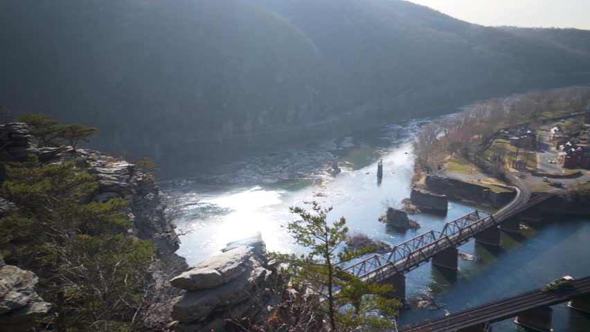 Slow pan to the right view of Harpers Ferry National Park and the confluence of the Potomac and Shenandoah Rivers from Maryland Heights.