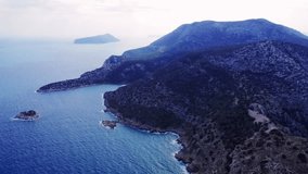Aerial video captures blend of mountain, sea, sky in Turkey, showcasing harmony of landscape. Scene reveals interaction of mountain, sea, sky in scenic view.