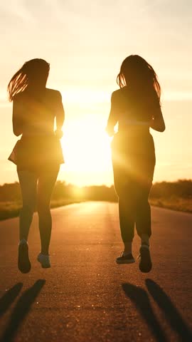 two friends running sunset, team group girls running sunset, silhouette athletic girls, teamwork triathlete running, team like-minded people, warming up before training, wellness, female power Royalty-Free Stock Footage #3457548169