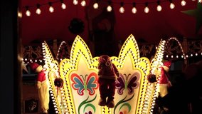 Merry go round at fun fair in darkness turning HD 1080 video footage 25 fps
