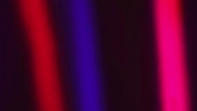 Abstract light streaks in vivid colors against a black background in a 4K loop footage.