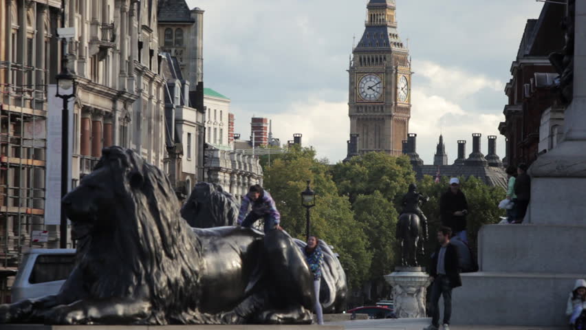 LONDON - OCTOBER 7, 2011: People climbing on Nelson's lions 