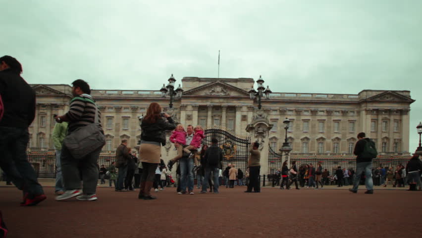 LONDON - OCTOBER 8, 2011: Unidentified people walk and take pictures in front of