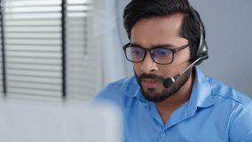Closeup face of indian or arabian man wearing headset and talking, business advisor, call center worker, company representative, support service operator, holds online consultation - Powered by Shutterstock - Get 15% off with code: PIKWIZARD15