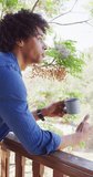 Vertical video of african american man drinking coffee in log cabin. Free time and domestic life concept.