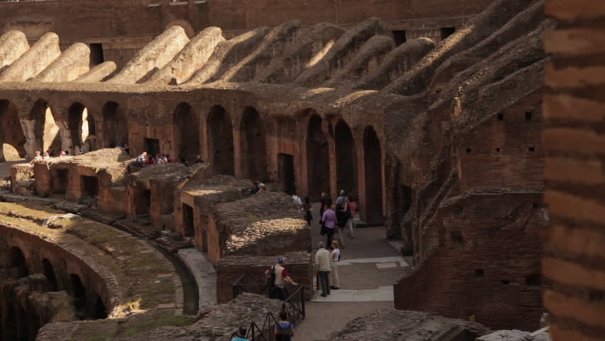 Tourists walking around taking pictures in the Colosseum. High-angle footage