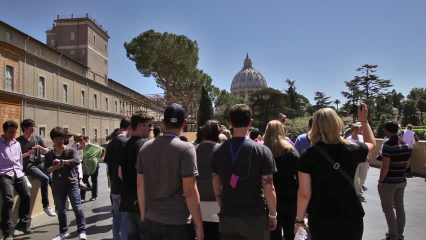 ROME - MAY 5, 2012: A small group of people congregates on the street with the